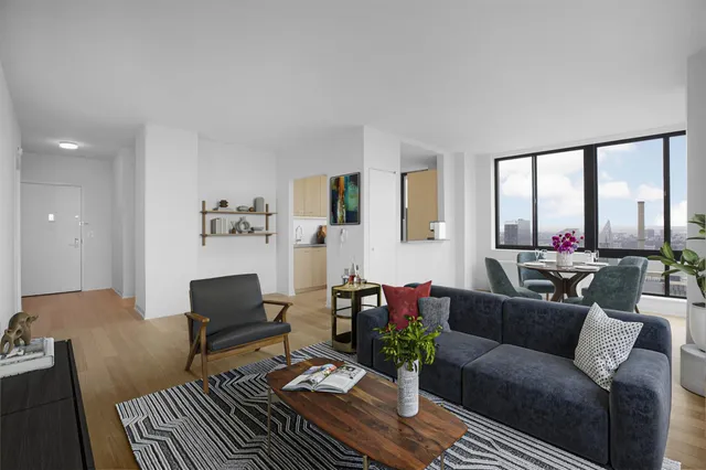 a living room with furniture or couch and a floor to ceiling window