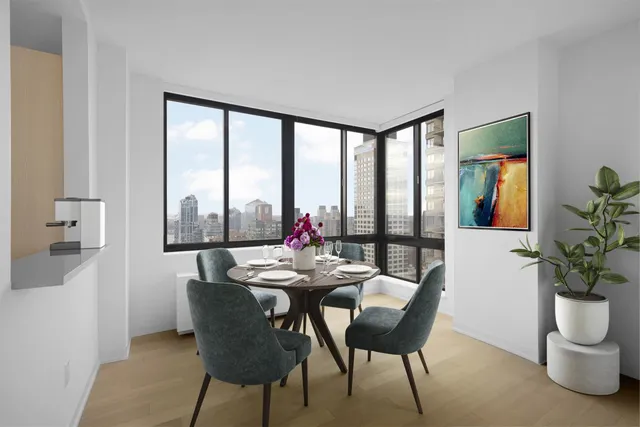 a view of a dining room with furniture large windows and wooden floor