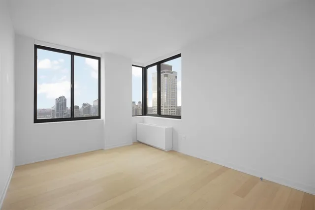 a bedroom with a bed and a potted plant