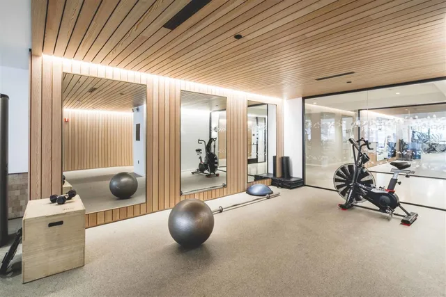 a front view of a building with glass windows and a table