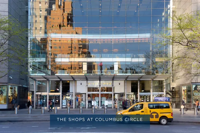 a view of building with cars parked