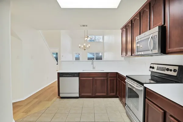 a kitchen with stainless steel appliances granite countertop a sink and a stove