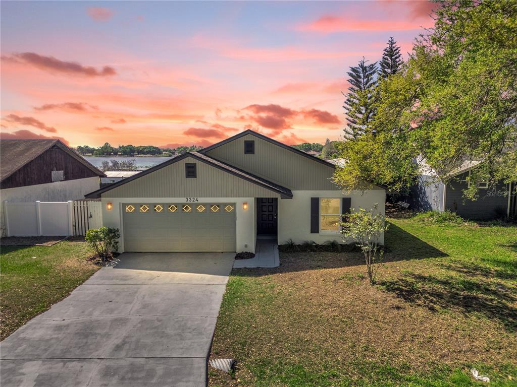 a front view of house with yard and garage