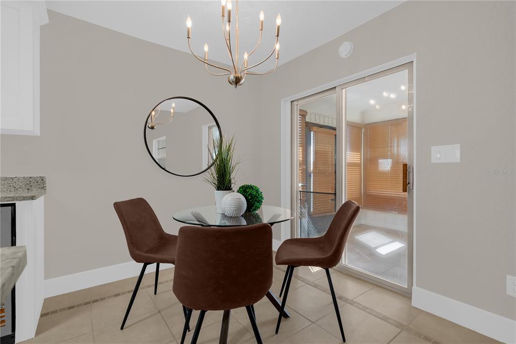 3324 Fox Ridge Drive Winter Haven, FL 33884 - Photo 13 of 28 a view of a dining room with furniture and a chandelier