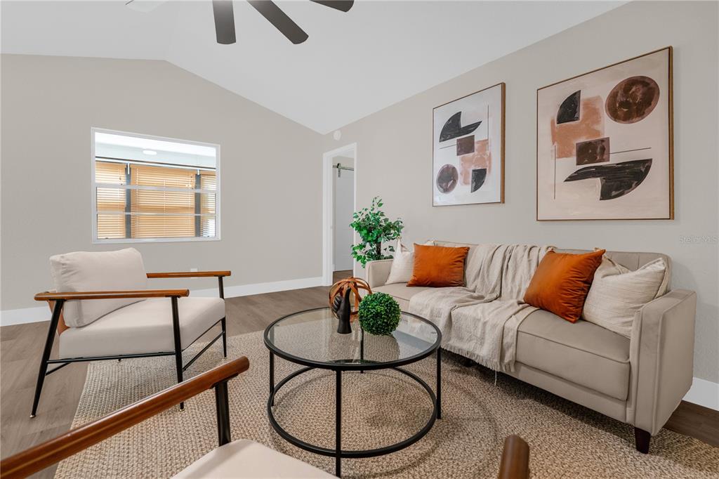 3324 Fox Ridge Drive Winter Haven, FL 33884 - Photo 14 of 28 a living room with furniture a rug and a window