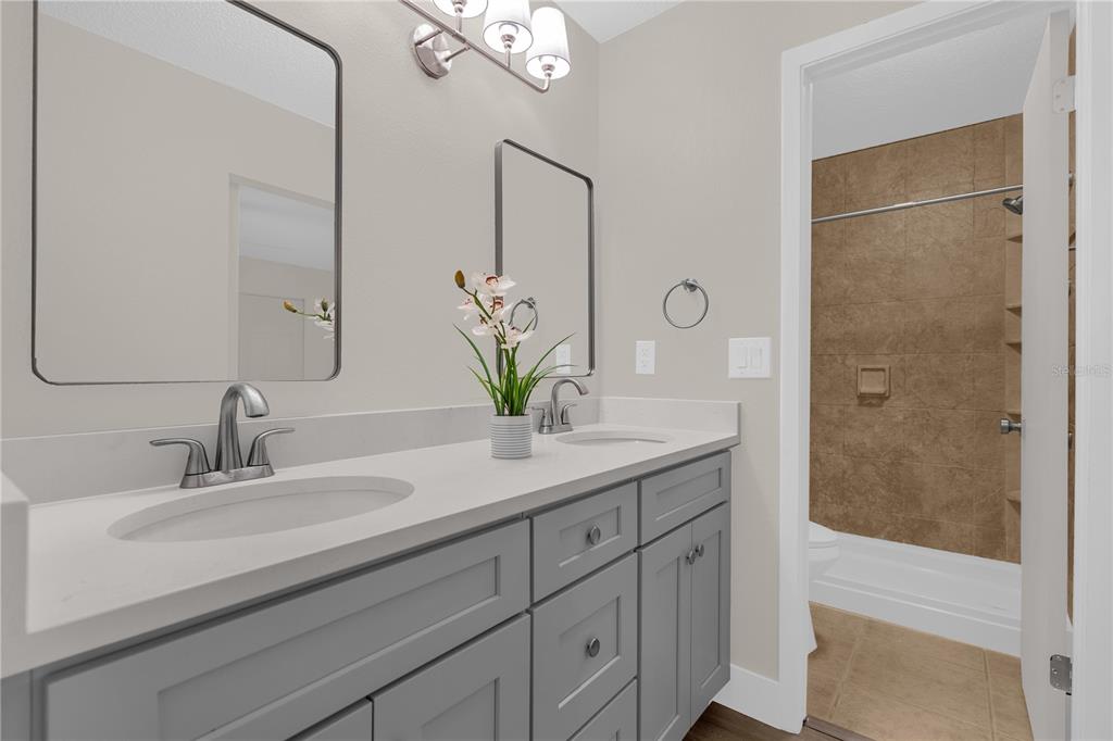 3324 Fox Ridge Drive Winter Haven, FL 33884 - Photo 19 of 28 a bathroom with a granite countertop sink a vanity and a mirror