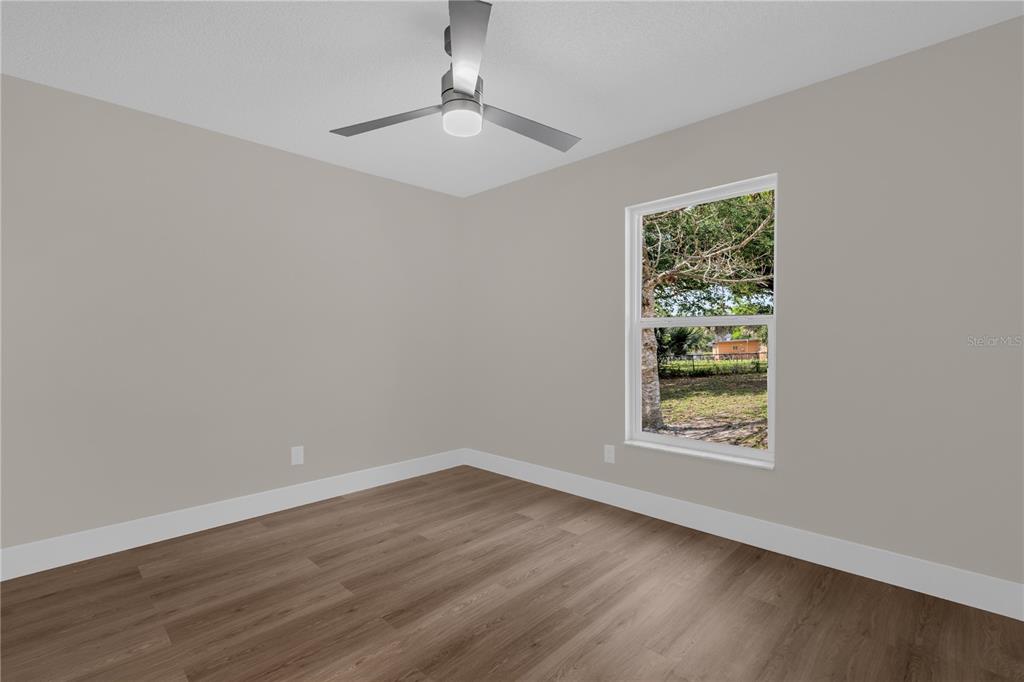 3324 Fox Ridge Drive Winter Haven, FL 33884 - Photo 20 of 28 a view of an empty room with wooden floor and a window