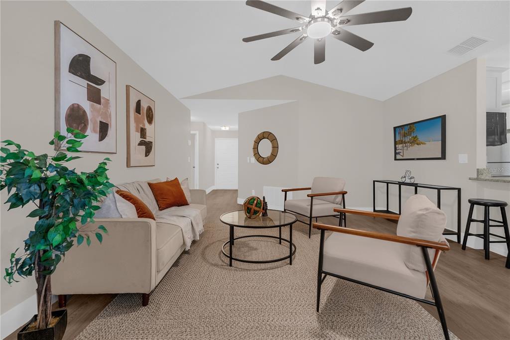 3324 Fox Ridge Drive Winter Haven, FL 33884 - Photo 6 of 28 a living room with furniture and a potted plant