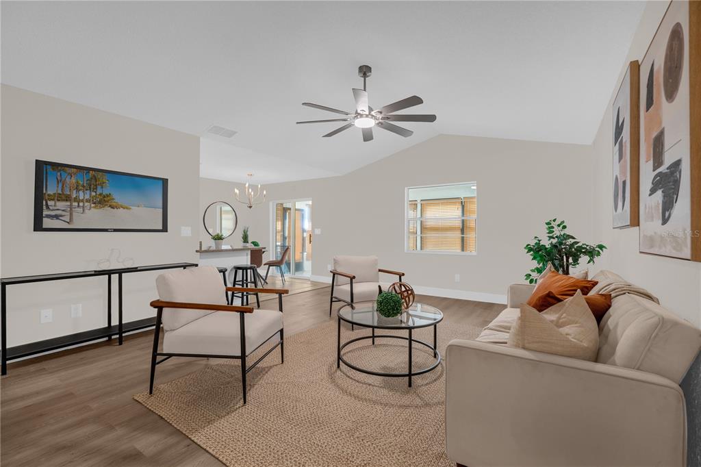 3324 Fox Ridge Drive Winter Haven, FL 33884 - Photo 7 of 28 a living room with furniture and a potted plant