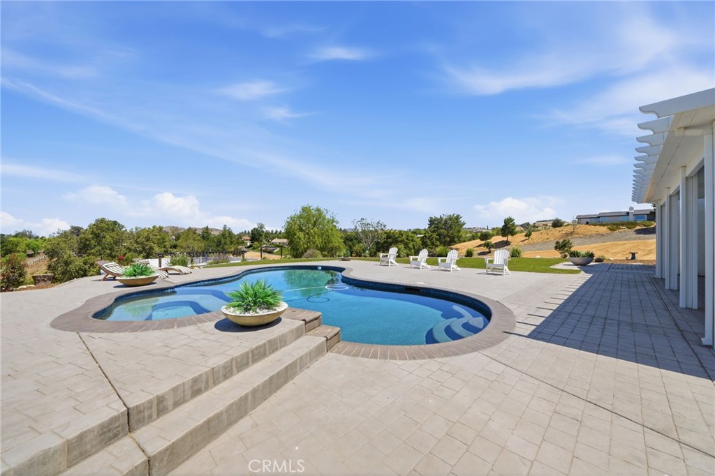 41110 Los Ranchos Circle Temecula, CA 92592 - Photo 54 of 77 a view of a swimming pool with a lounge chair
