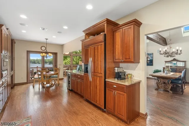 a kitchen with a table chairs stove and wooden floor