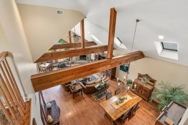a living room with furniture a flat screen tv and kitchen view
