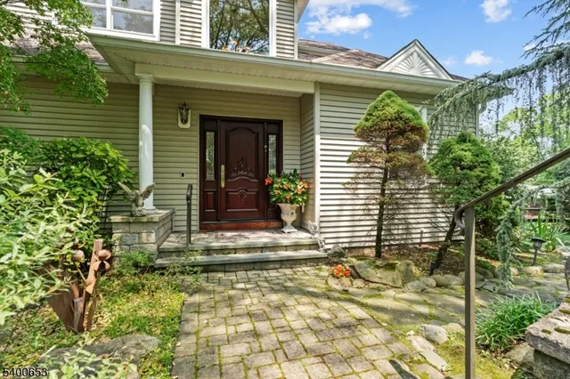 a view of a house with a small window and potted plants