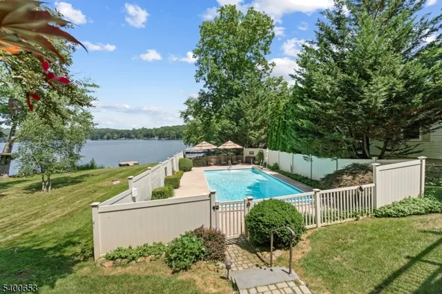 a view of a lake with table and chairs