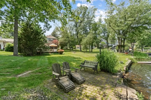 a view of a house with a yard and sitting area