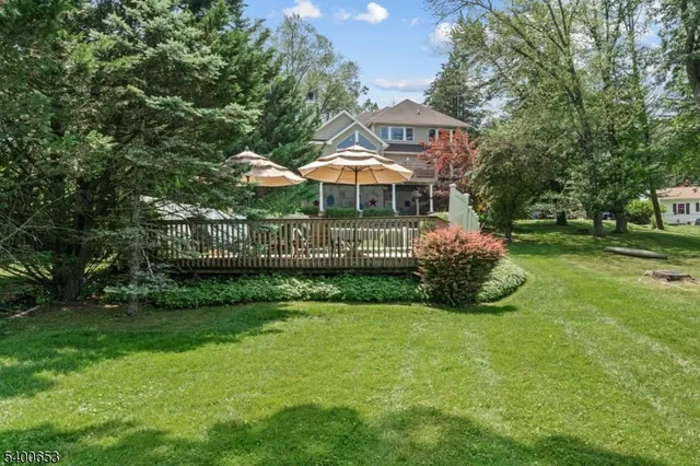an aerial view of a house with a yard and lake view