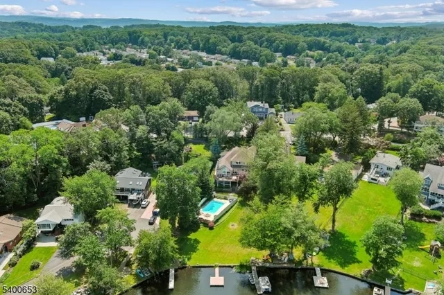 an aerial view of a house with a yard basket ball court and outdoor seating