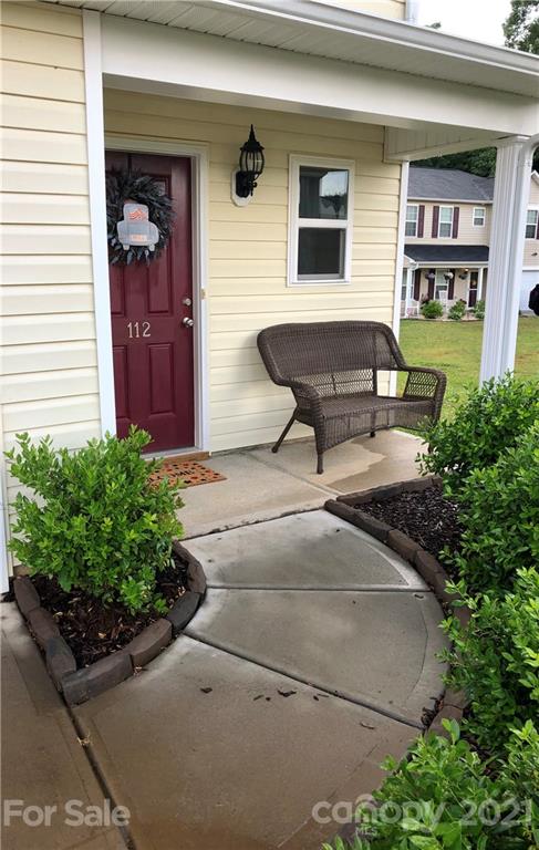 112 York Place Linwood, NC 27299 - Photo 2 of 25 a roof deck with table and chairs and potted plants