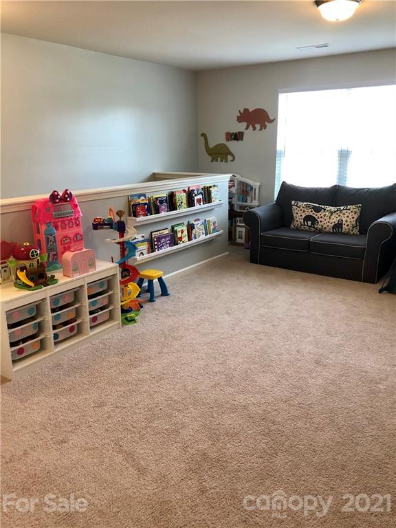 112 York Place Linwood, NC 27299 - Photo 11 of 25 a bedroom with furniture and a book shelf