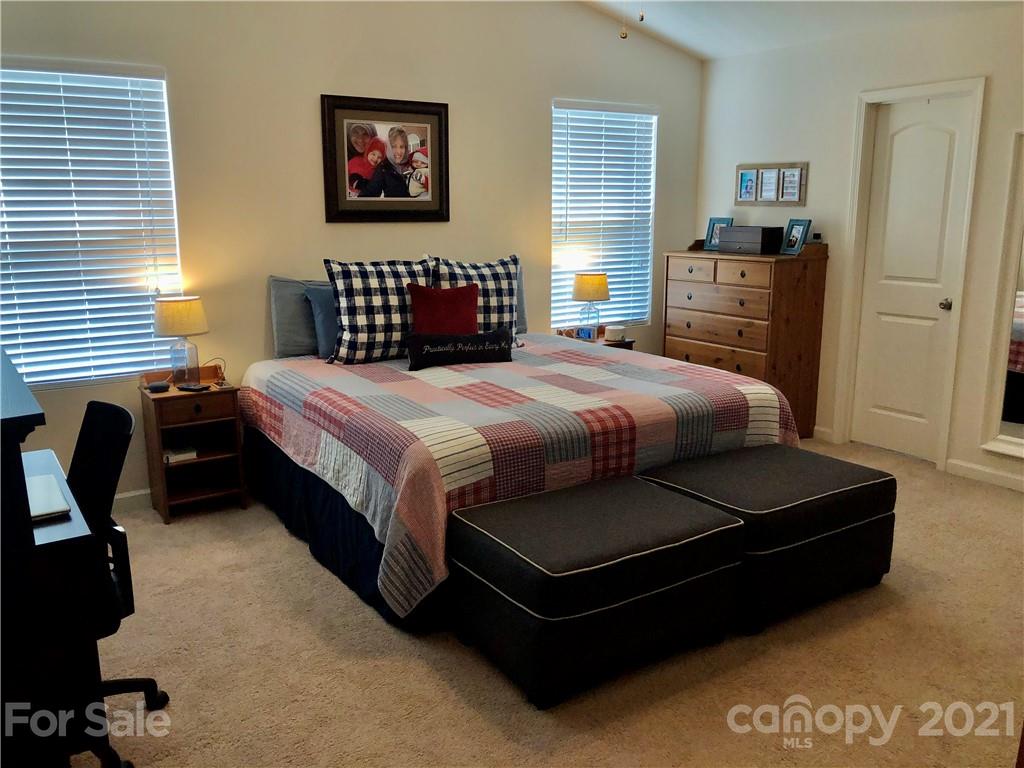 112 York Place Linwood, NC 27299 - Photo 15 of 25 a bedroom with a bed and dresser with wooden floor