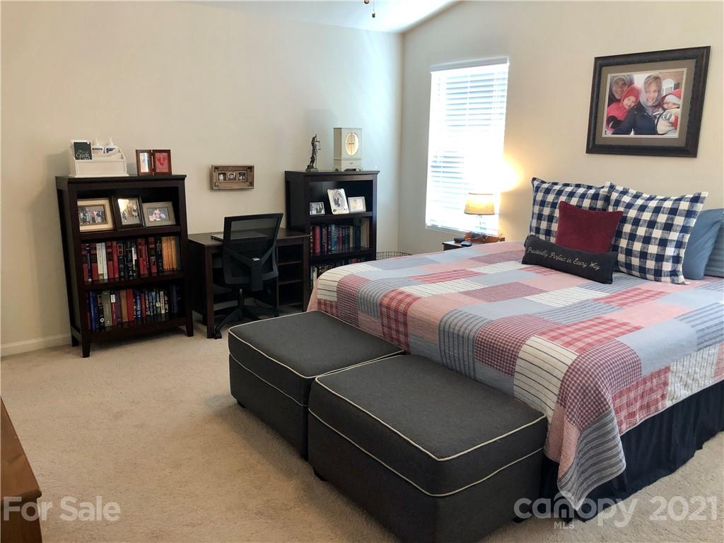 112 York Place Linwood, NC 27299 - Photo 16 of 25 a bedroom with a bed cabinets and window