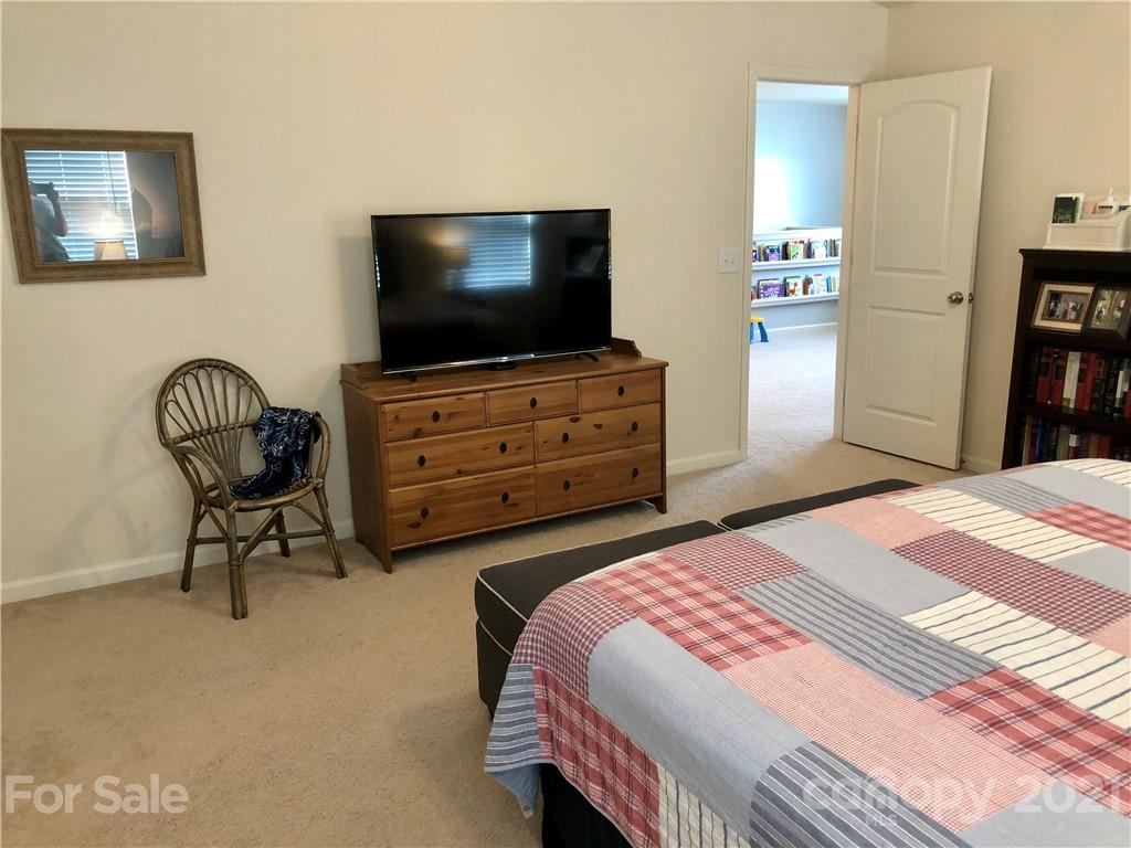 112 York Place Linwood, NC 27299 - Photo 17 of 25 a bedroom with a bed and a flat screen tv