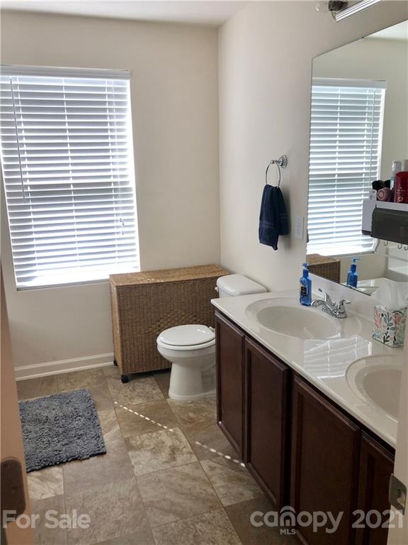 112 York Place Linwood, NC 27299 - Photo 18 of 25 a bathroom with a sink toilet a mirror and bathtub