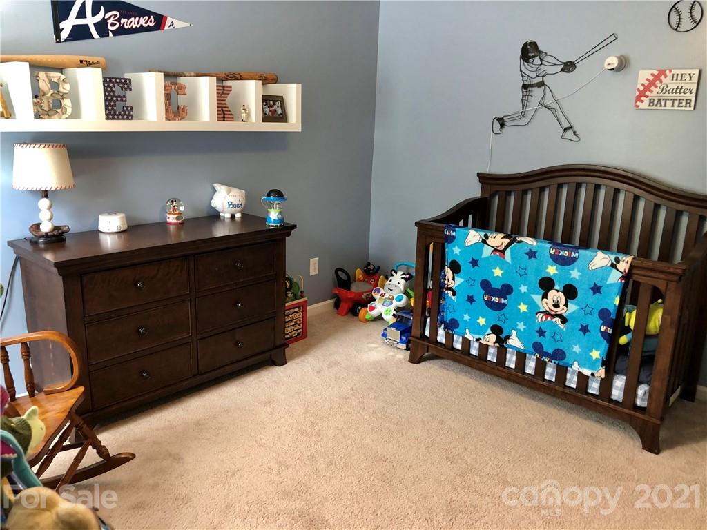 112 York Place Linwood, NC 27299 - Photo 23 of 25 a bedroom with furniture and a baby crib