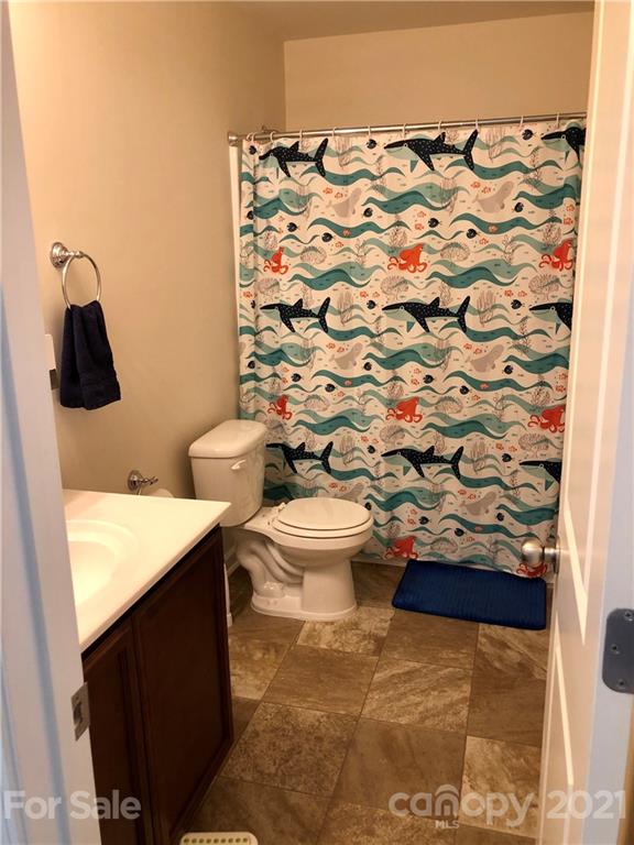 112 York Place Linwood, NC 27299 - Photo 25 of 25 a bathroom with a toilet and a shower curtain