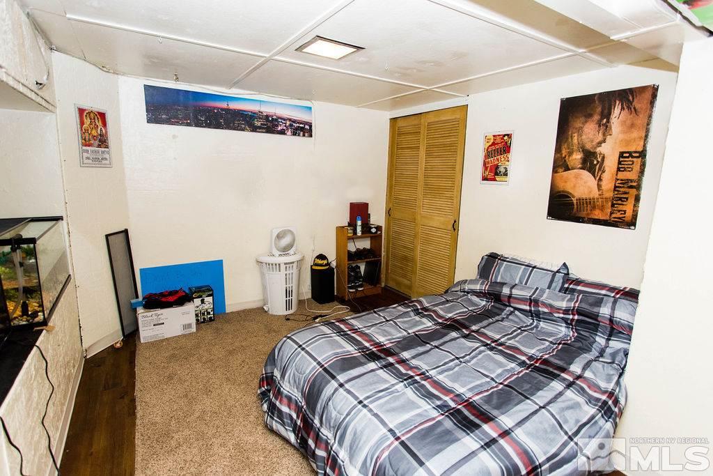 1135 Ralston Street Reno, NV 89503 - Photo 16 of 31 a bedroom with a bed and wooden floor
