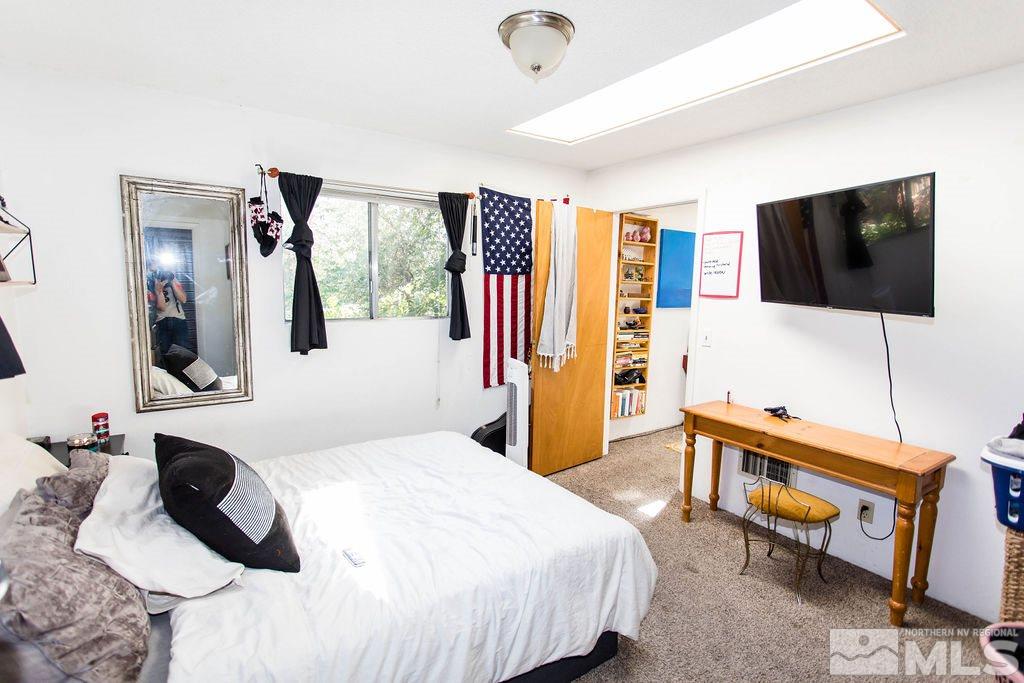 1135 Ralston Street Reno, NV 89503 - Photo 19 of 31 a bedroom with a bed and a flat screen tv