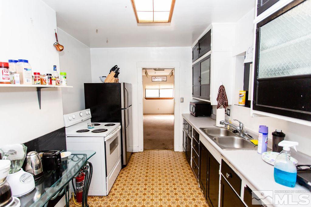 1135 Ralston Street Reno, NV 89503 - Photo 6 of 31 a kitchen with stainless steel appliances a stove refrigerator sink and a microwave