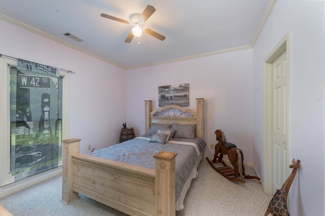 2121 Lee Road Salem, AL 36874 - Photo 20 of 29 a bedroom with a bed and a chandelier