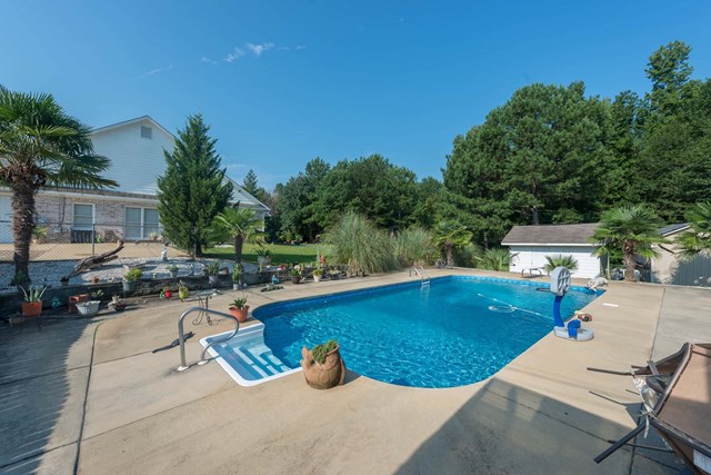 2121 Lee Road Salem, AL 36874 - Photo 27 of 29 a view of a swimming pool with chairs in patio