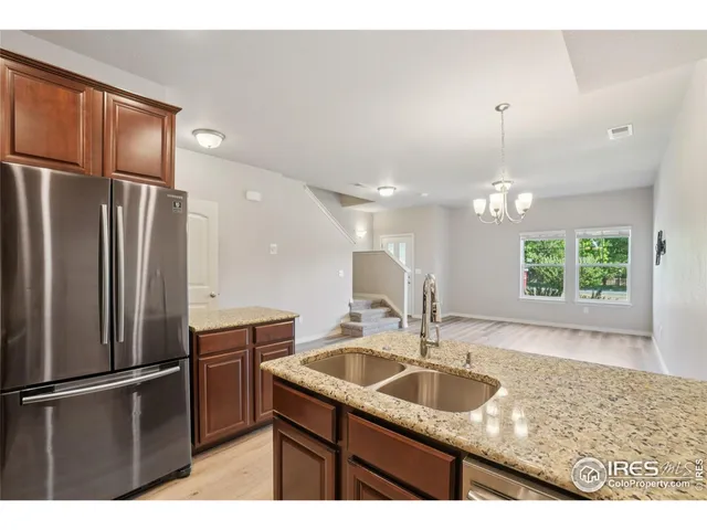 a kitchen with kitchen island a sink stainless steel appliances and cabinets