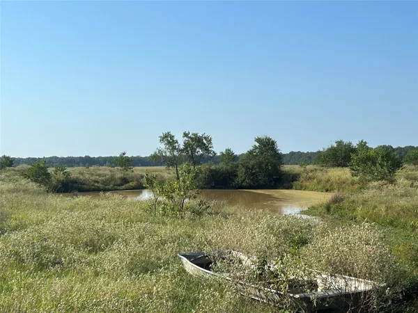 a view of a lake with houses in the back