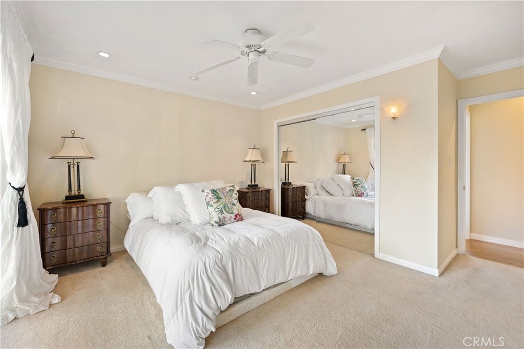 3008 Cisco Court Simi Valley, CA 93063 - Photo 17 of 34 Primary bedroom with double door mirrored wardrobe closet & a ceiling fan