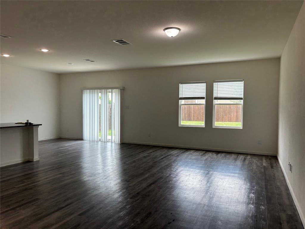 6229 Old Bridge Way Forney, TX 75126 - Photo 4 of 20 a view of an empty room with wooden floor and a window