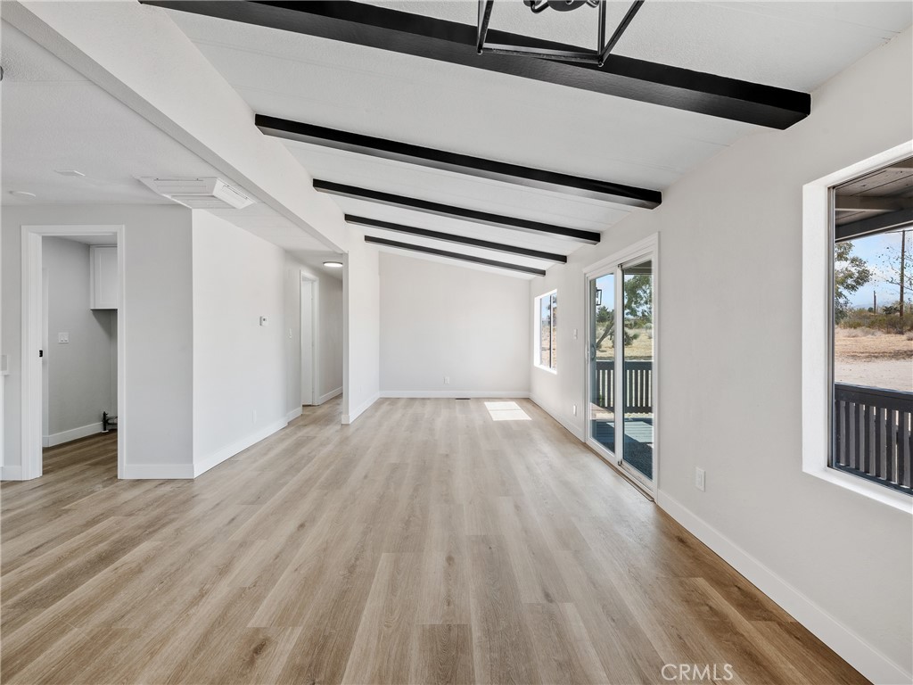 11669 Sahara Road Phelan, CA 92371 - Photo 6 of 34 a view of empty room with wooden floor and fan
