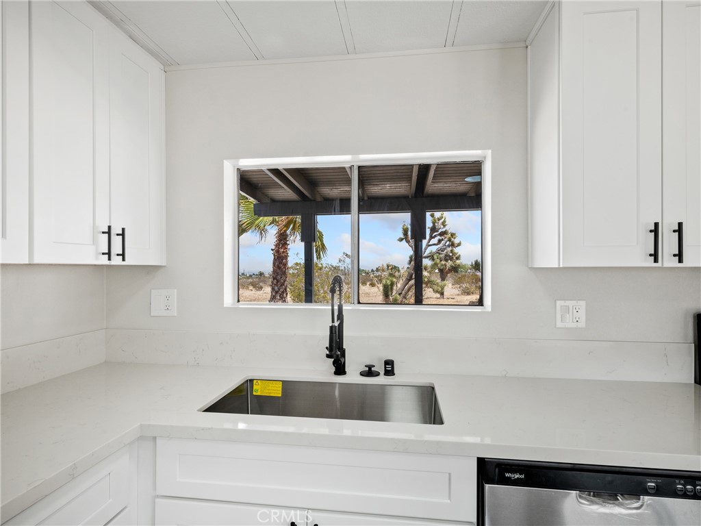 11669 Sahara Road Phelan, CA 92371 - Photo 8 of 34 a bathroom with a two sinks a vanity and a large window