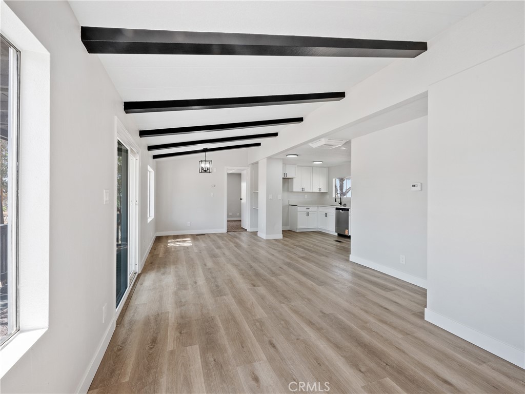 11669 Sahara Road Phelan, CA 92371 - Photo 10 of 34 a view of empty room with wooden floor