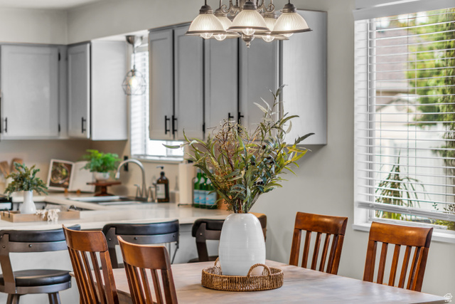 8029 Old Dairy Road Sandy, UT 84094 - Photo 11 of 37 Recessed lighting, wood-finish dining table, chandelier, and a window with horizontal blinds
