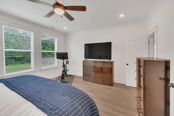 a bedroom with a bed and a flat screen tv