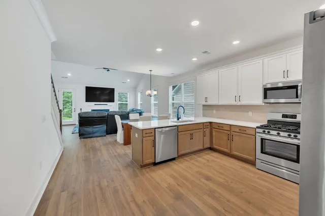 a kitchen with granite countertop a stove top oven and cabinets