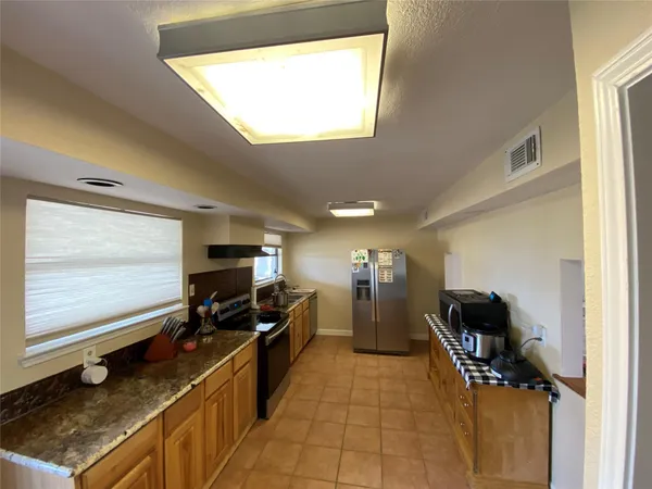 a kitchen with a sink stainless steel appliances and cabinets