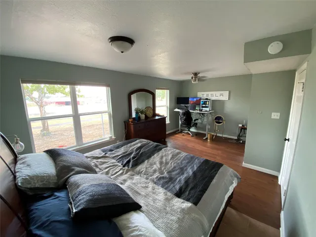 a bedroom with furniture and a large window