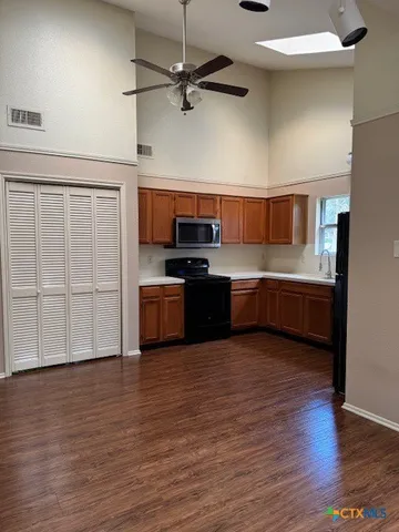a kitchen with stainless steel appliances a sink and a refrigerator