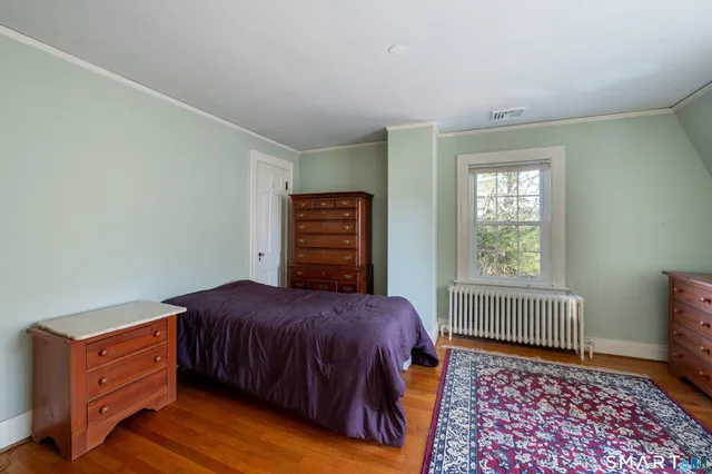 a bedroom with a bed and dresser