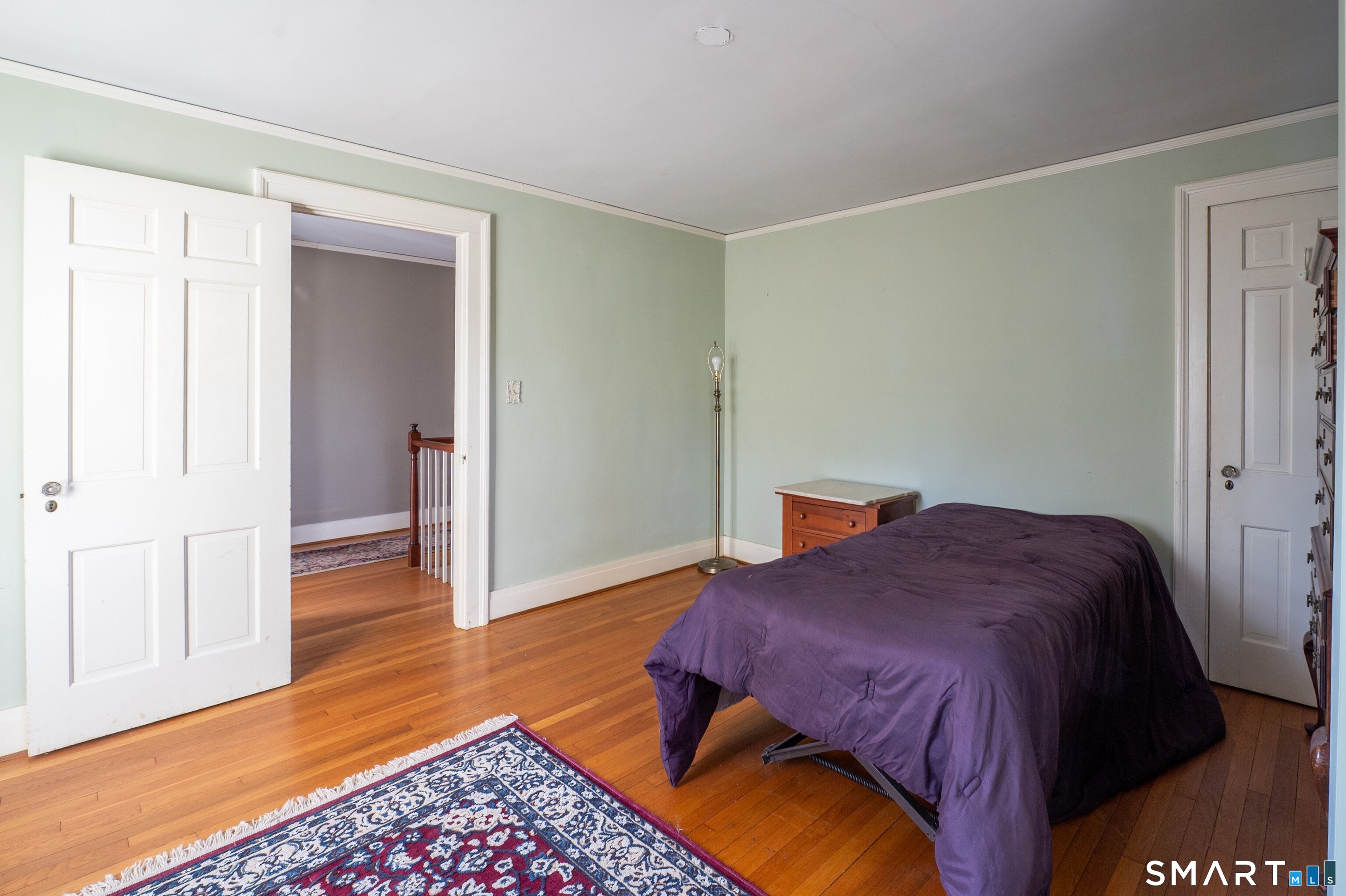 570 North Main Street Wallingford, CT 06492 - Photo 19 of 40 a bedroom with a bed and wooden floor