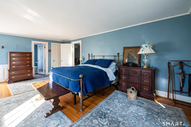 a bedroom with a bed and a television